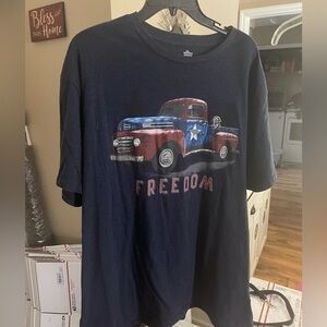 Freedom, a truck, a dog and red, white and blue. Shirt is Navy. 2XL (50-52).